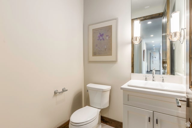 bathroom featuring toilet and vanity
