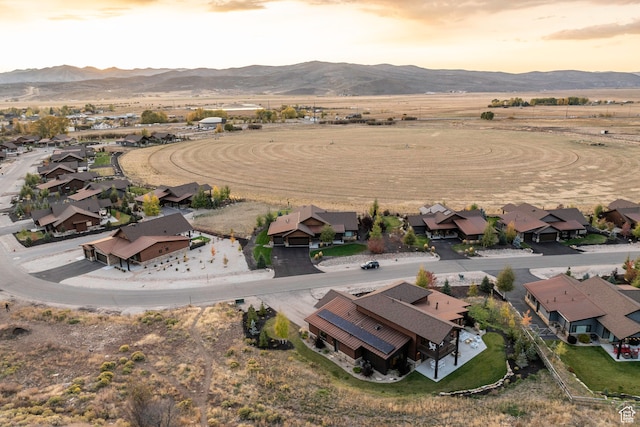 aerial view at dusk featuring a mountain view