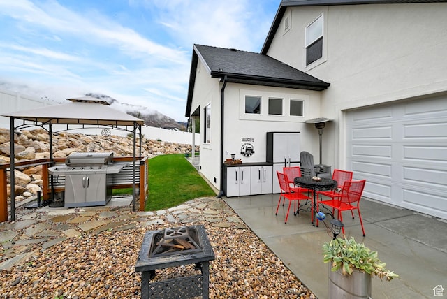 170 E 3900 N, North Ogden, UT 84414 - view of patio with a fire pit, a grill, a gazebo, and a garage