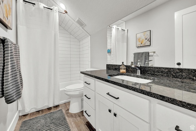 170 E 3900 N, North Ogden, UT 84414 - full bath with vanity, wood finished floors, toilet, shower / tub combo with curtain, and a textured ceiling