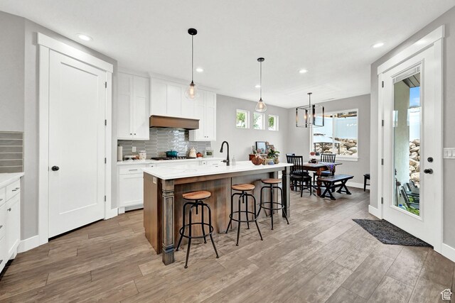 170 E 3900 N, North Ogden, UT 84414 - kitchen featuring gas stovetop, a breakfast bar area, decorative backsplash, white cabinets, and recessed lighting