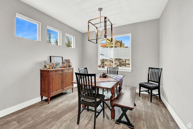 170 E 3900 N, North Ogden, UT 84414 - dining room featuring a chandelier, light wood-style flooring, and baseboards
