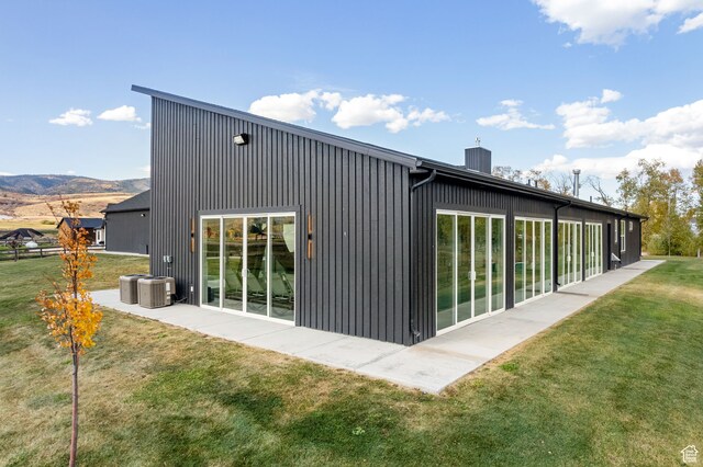 70 W 350 S, Garden City, UT 84028 - view of side of property with a patio, cooling unit, a lawn, and a mountain view