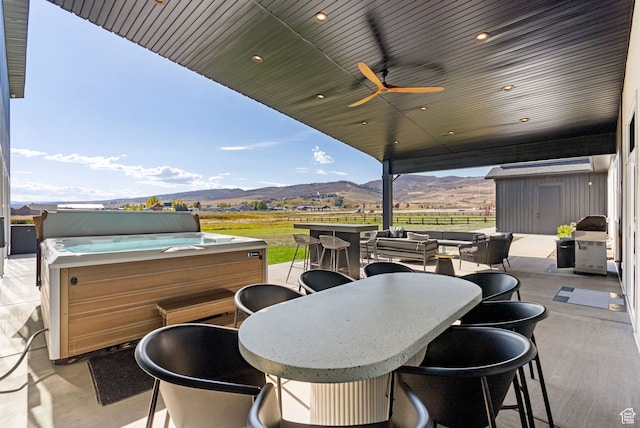 70 W 350 S, Garden City, UT 84028 - view of patio featuring a hot tub, a storage unit, a mountain view, and ceiling fan