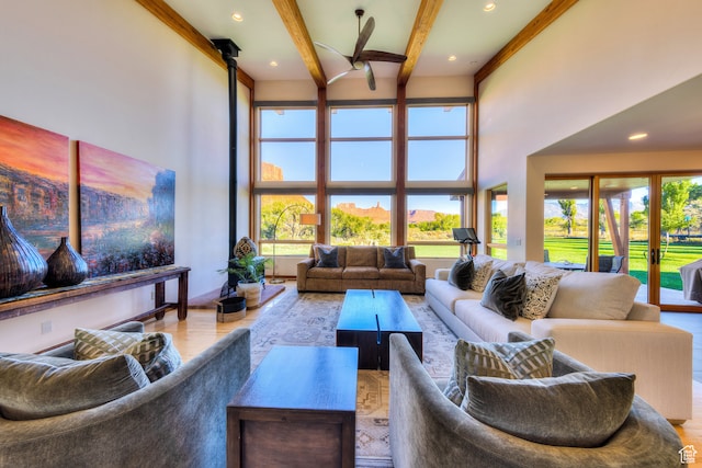 425 Amber Ln, Castle Valley, UT 84532 - living room with ceiling fan, ornamental molding, beamed ceiling, a high ceiling, and light hardwood / wood-style floors