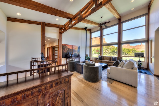 425 Amber Ln, Castle Valley, UT 84532 - living room with beamed ceiling, a high ceiling, and light wood-type flooring