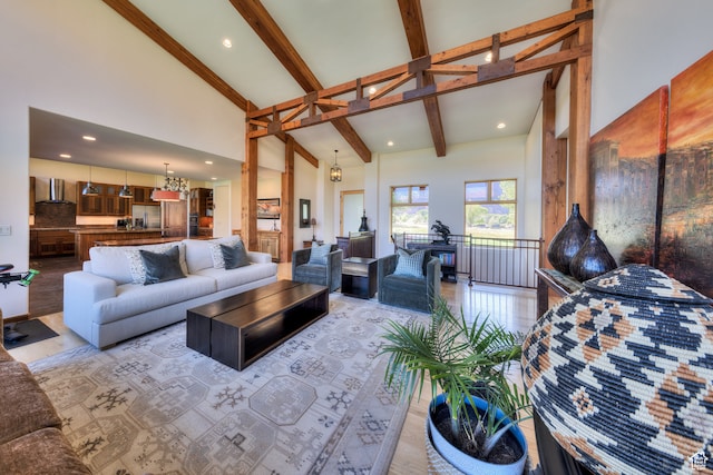 425 Amber Ln, Castle Valley, UT 84532 - living room with beam ceiling, high vaulted ceiling, light hardwood / wood-style flooring, and a chandelier