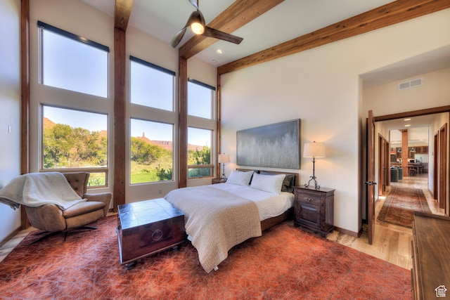 425 Amber Ln, Castle Valley, UT 84532 - bedroom featuring a towering ceiling, hardwood / wood-style floors, beamed ceiling, and ceiling fan