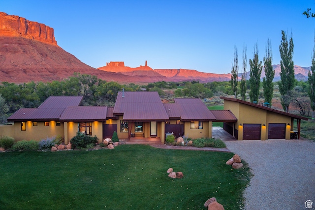 425 Amber Ln, Castle Valley, UT 84532 - view of front of property featuring a mountain view, a garage, and a front lawn