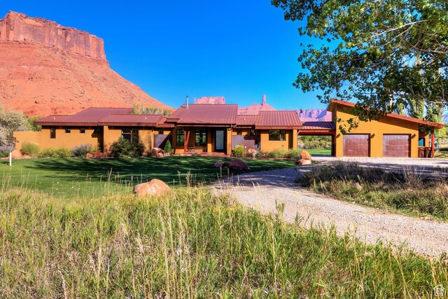 425 Amber Ln, Castle Valley, UT 84532 - view of front of property featuring a mountain view and a garage