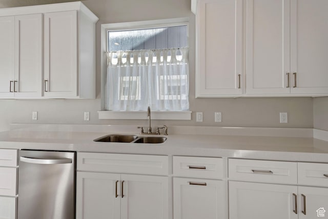 kitchen with dishwasher, white cabinetry, a sink, and light countertops