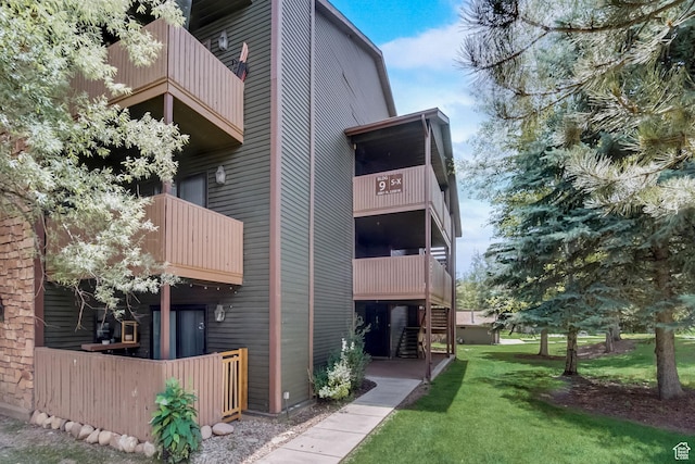 6861 N 2200 W Unit 9U, Park City, UT 84098 - rear view of property featuring a lawn and a balcony