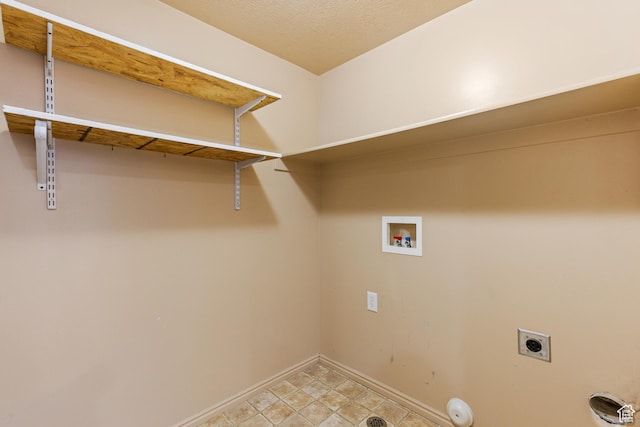 clothes washing area with baseboards, washer hookup, laundry area, and electric dryer hookup