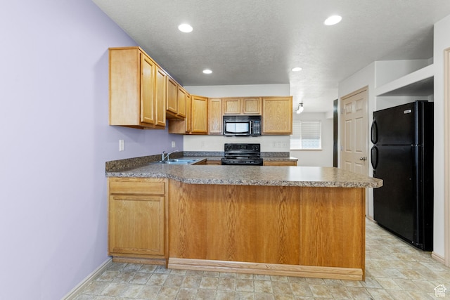 kitchen with a peninsula, a sink, black appliances, and recessed lighting