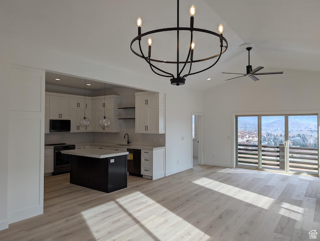 556 N Olympic Way Unit 38, Midway, UT 84049 - kitchen featuring black appliances, open floor plan, a chandelier, a center island, and high vaulted ceiling
