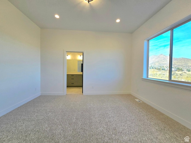 556 N Olympic Way Unit 38, Midway, UT 84049 - empty room featuring light colored carpet, recessed lighting, baseboards, and a mountain view