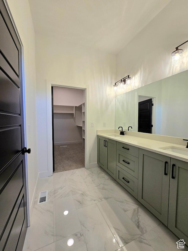 556 N Olympic Way Unit 38, Midway, UT 84049 - bathroom with double vanity, marble finish flooring, a spacious closet, and baseboards