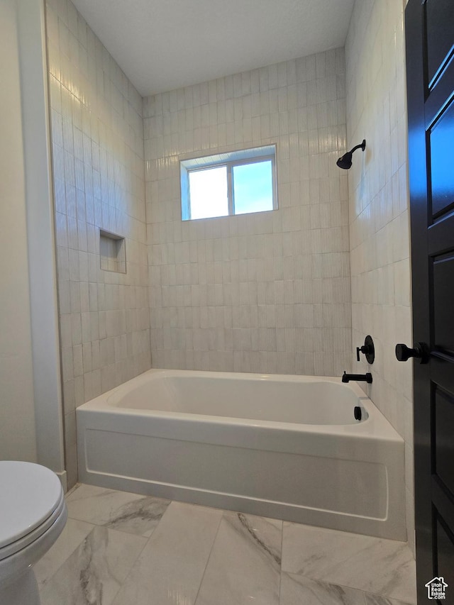 556 N Olympic Way Unit 38, Midway, UT 84049 - bathroom featuring marble look tiles, toilet, and shower / tub combination