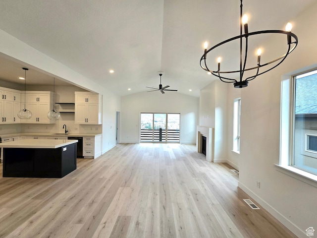 556 N Olympic Way Unit 38, Midway, UT 84049 - unfurnished living room with a sink, ceiling fan, light wood-style flooring, a chandelier, and baseboards