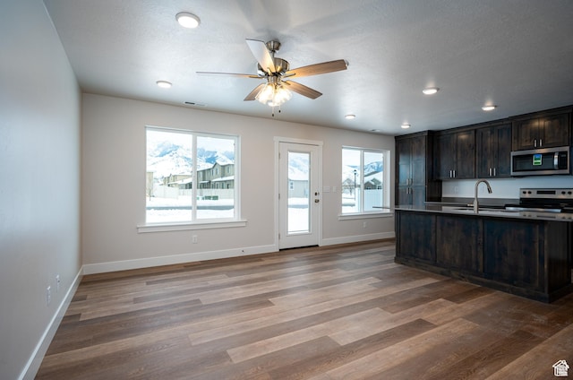 655 S 85 E Unit 32, Smithfield, UT 84335 - kitchen with appliances with stainless steel finishes, baseboards, dark brown cabinets, wood finished floors, and recessed lighting