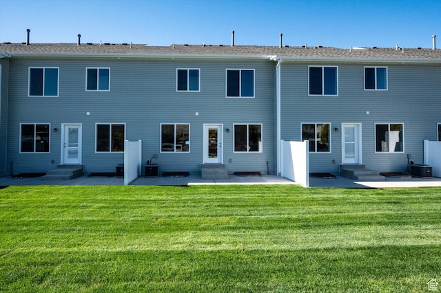 655 S 85 E Unit 32, Smithfield, UT 84335 - back of property featuring entry steps, a patio area, a lawn, and central air condition unit