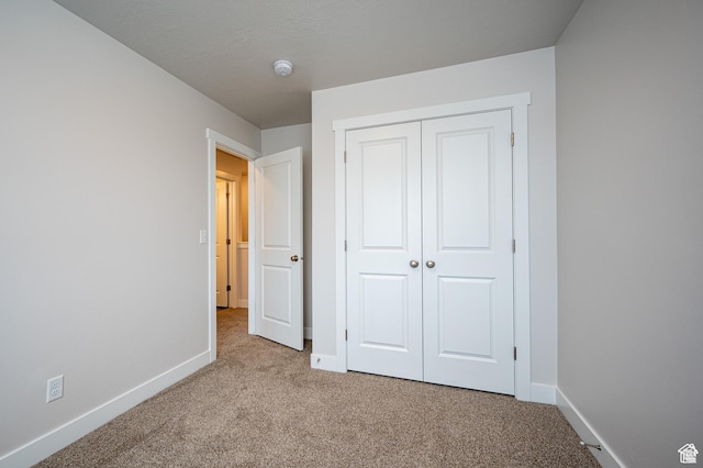 655 S 85 E Unit 32, Smithfield, UT 84335 - unfurnished bedroom with carpet, baseboards, and a closet