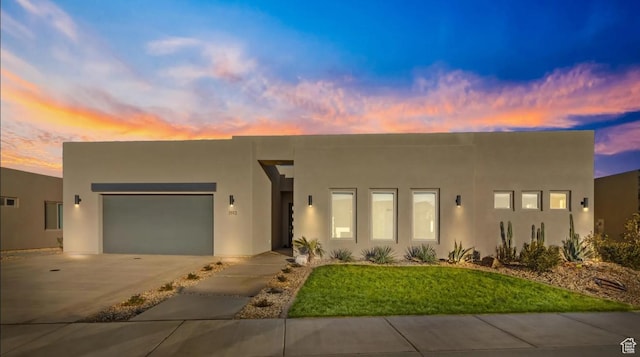 3193 S Hideaway Pl, Hurricane, UT 84737 - view of front of property featuring a lawn, a garage, stucco siding, and concrete driveway