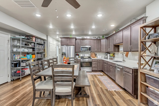 1441 E Snowflake Ave N, Eagle Mountain, UT 84005 - kitchen with sink, appliances with stainless steel finishes, light hardwood / wood-style flooring, and dark brown cabinets