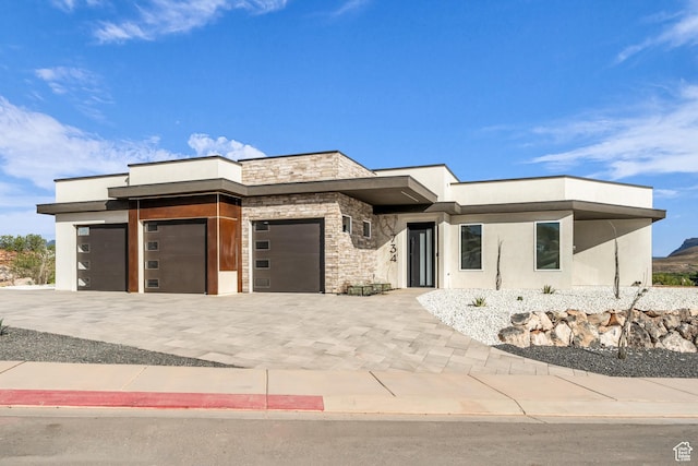 734 S 1220 W, Hurricane, UT 84737 - prairie-style house with a garage, stucco siding, decorative driveway, and stone siding