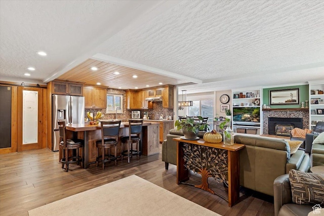 1286 N Fairfield E, Layton, UT 84040 - living room with hardwood / wood-style floors, a barn door, plenty of natural light, and a tiled fireplace