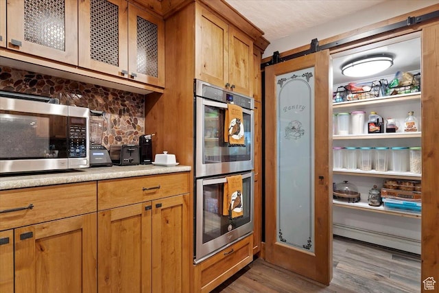 1286 N Fairfield E, Layton, UT 84040 - kitchen featuring appliances with stainless steel finishes, a barn door, and dark wood-type flooring