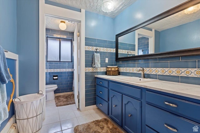 1286 N Fairfield E, Layton, UT 84040 - bathroom featuring tile patterned flooring, a textured ceiling, toilet, vanity, and tile walls