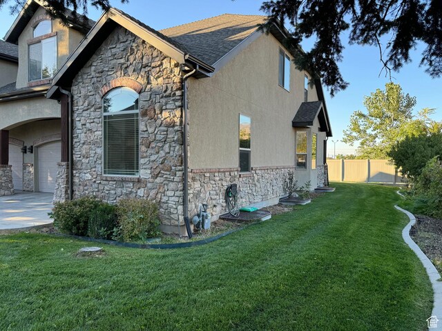 1260 N 200 W, Bountiful, UT 84010 - view of home's exterior featuring fence, a lawn, and stone siding