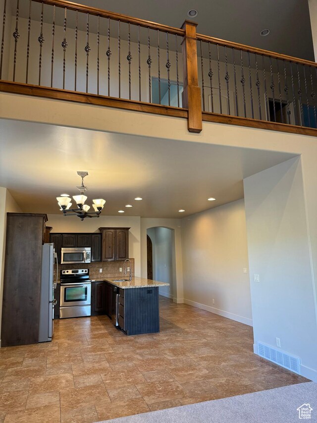 1260 N 200 W, Bountiful, UT 84010 - kitchen featuring a notable chandelier, appliances with stainless steel finishes, a sink, arched walkways, and visible vents