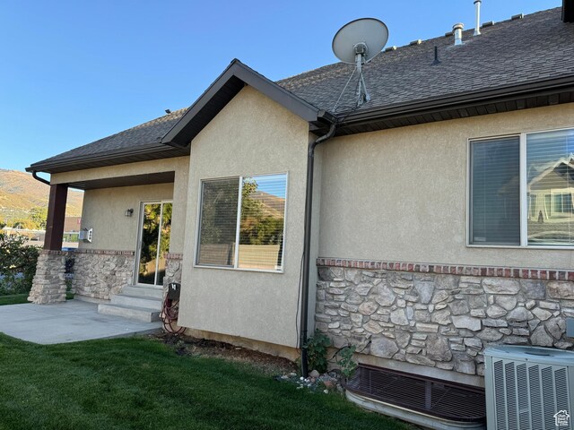1260 N 200 W, Bountiful, UT 84010 - view of property exterior with stone siding, a patio area, central air condition unit, entry steps, and stucco siding