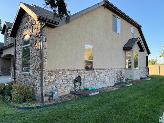 1260 N 200 W, Bountiful, UT 84010 - view of property exterior with a lawn, fence, stucco siding, and stone siding