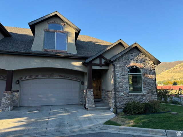 1260 N 200 W, Bountiful, UT 84010 - craftsman house featuring roof with shingles, a mountain view, concrete driveway, stone siding, and stucco siding