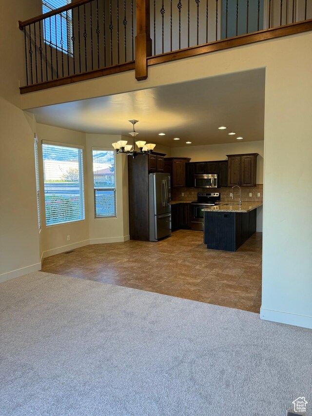 1260 N 200 W, Bountiful, UT 84010 - unfurnished living room with an inviting chandelier, light carpet, baseboards, recessed lighting, and a sink