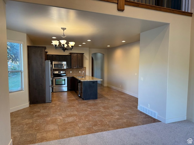 1260 N 200 W, Bountiful, UT 84010 - kitchen featuring appliances with stainless steel finishes, a notable chandelier, arched walkways, baseboards, and visible vents