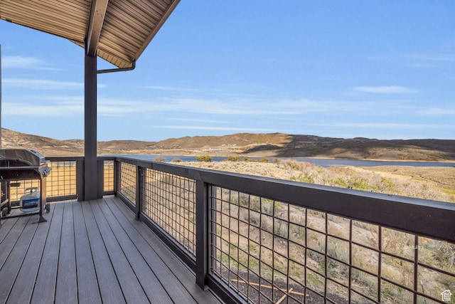 deck featuring grilling area and a water and mountain view