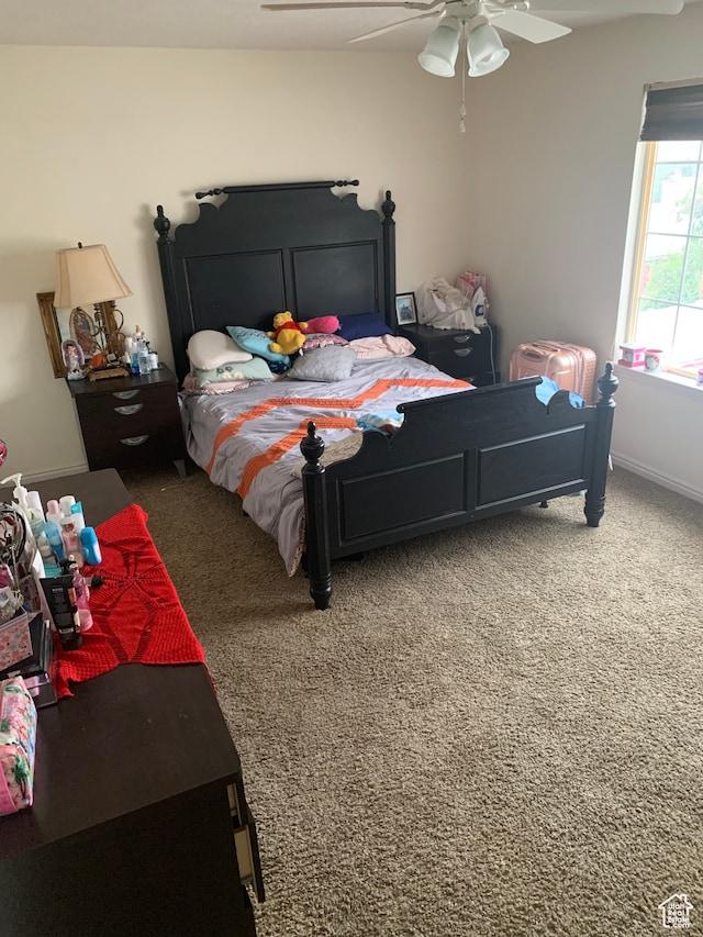 bedroom with ceiling fan and dark carpet