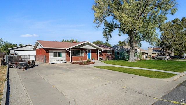 535 N 300 E, Brigham City, UT 84302 - ranch-style home with fence, a front lawn, brick siding, a gate, and concrete driveway