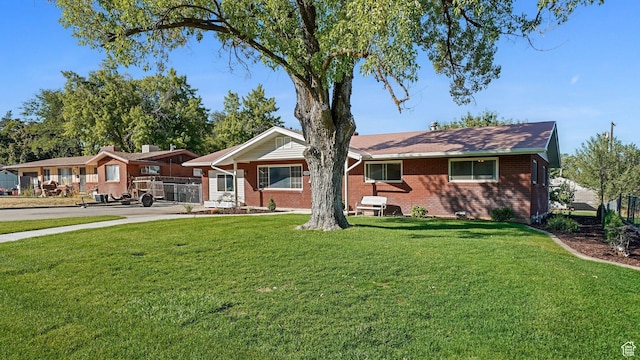 535 N 300 E, Brigham City, UT 84302 - ranch-style home with brick siding, fence, and a front yard