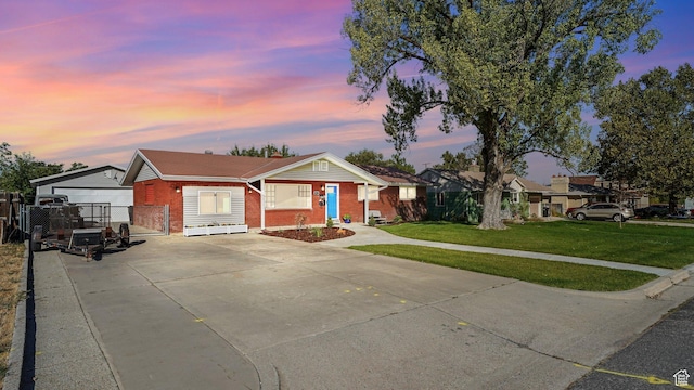 535 N 300 E, Brigham City, UT 84302 - ranch-style home with brick siding, a yard, driveway, and fence