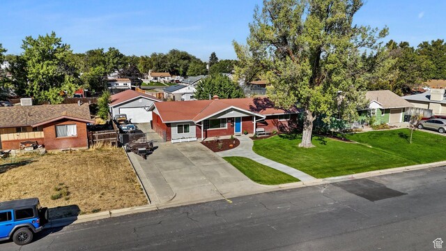 535 N 300 E, Brigham City, UT 84302 - view of front of house with brick siding, a residential view, a front yard, and concrete driveway