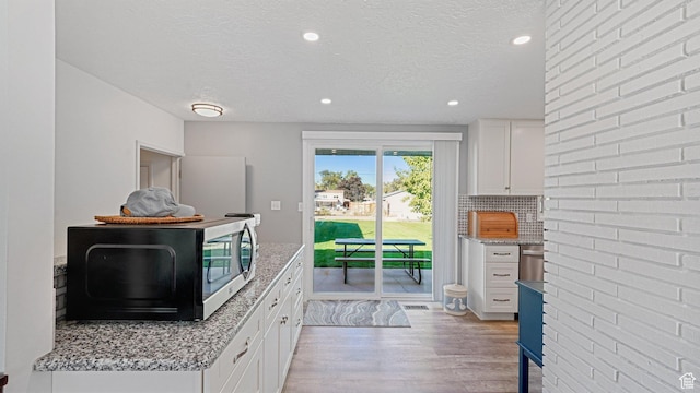 535 N 300 E, Brigham City, UT 84302 - doorway to outside featuring recessed lighting, a textured ceiling, light wood finished floors, and visible vents