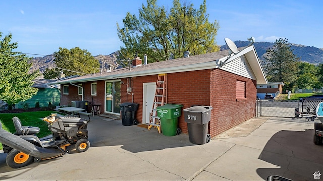 535 N 300 E, Brigham City, UT 84302 - view of home's exterior with brick siding, a mountain view, fence, and a patio