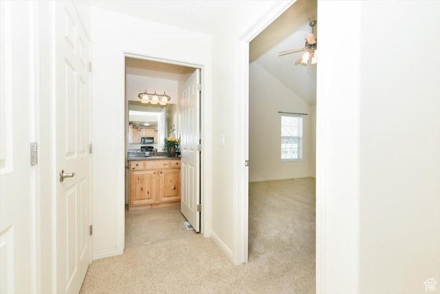 242 E 2230 N Unit A, North Logan, UT 84341 - hallway featuring light colored carpet, vaulted ceiling, and baseboards