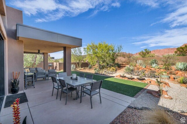 644 W Wild Indigo Way, Ivins, UT 84738 - view of patio / terrace with a fenced backyard, an outdoor living space, and outdoor dining area