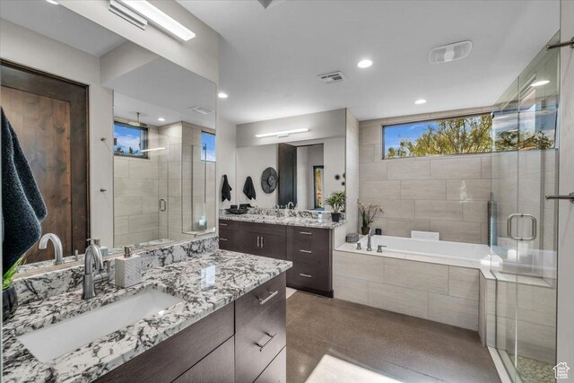 644 W Wild Indigo Way, Ivins, UT 84738 - bathroom featuring two vanities, a shower stall, a sink, visible vents, and a garden tub